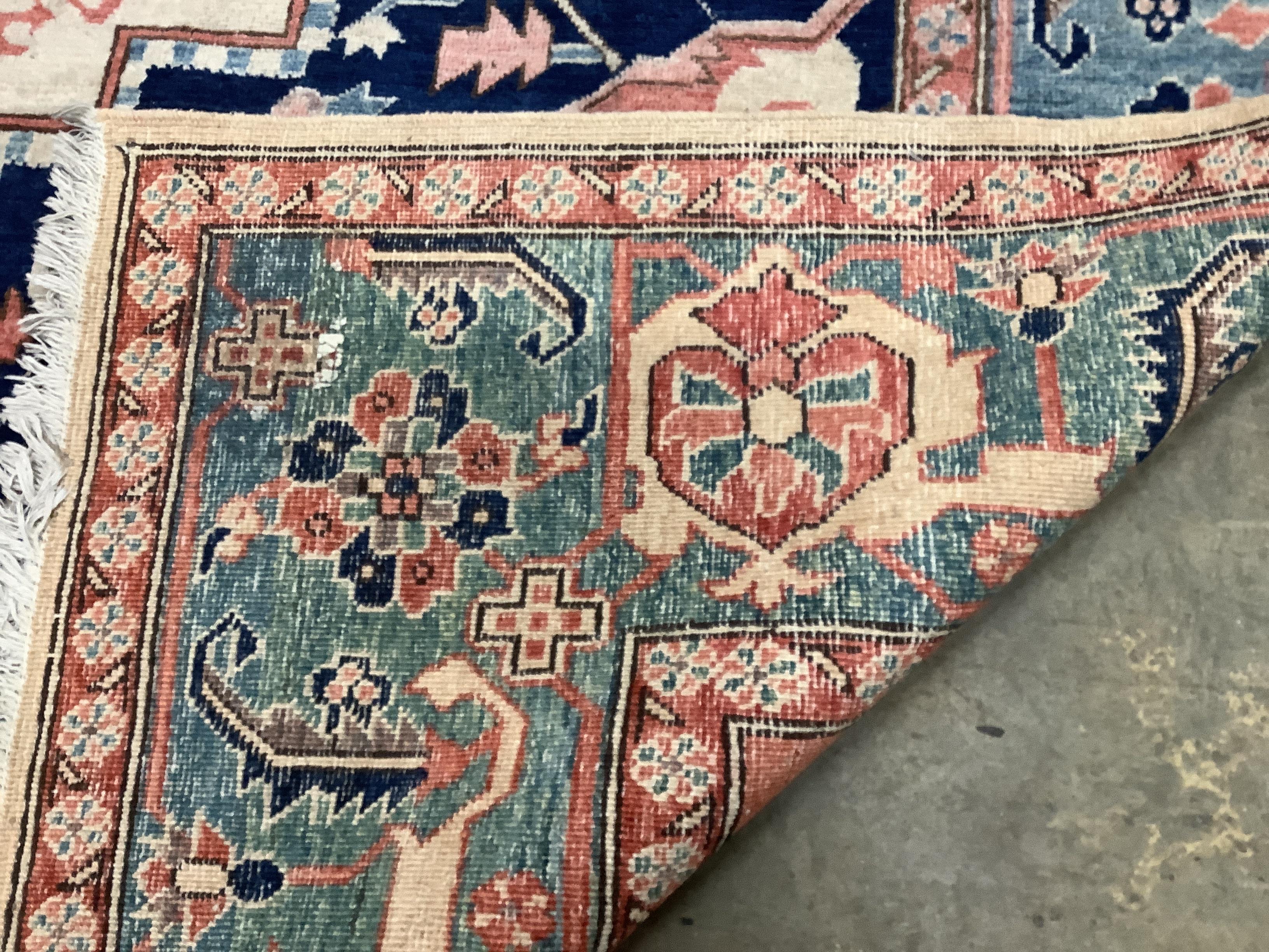A Heriz ivory ground carpet, 350 x 272cm
